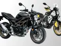 Due moto bicilindriche affiancate: una Suzuki SV nera e una moto da avventura gialla e bianca.