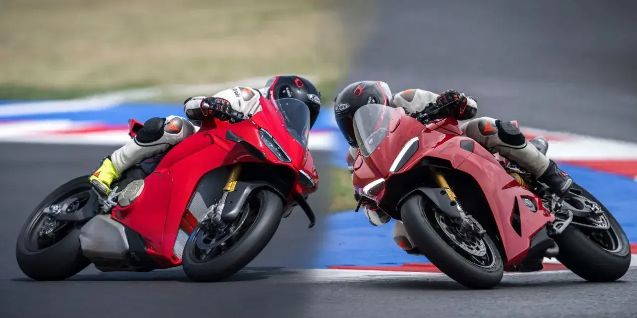 Due superbike Ducati rosse sfrecciano in pista, piegando in curva con maestria.