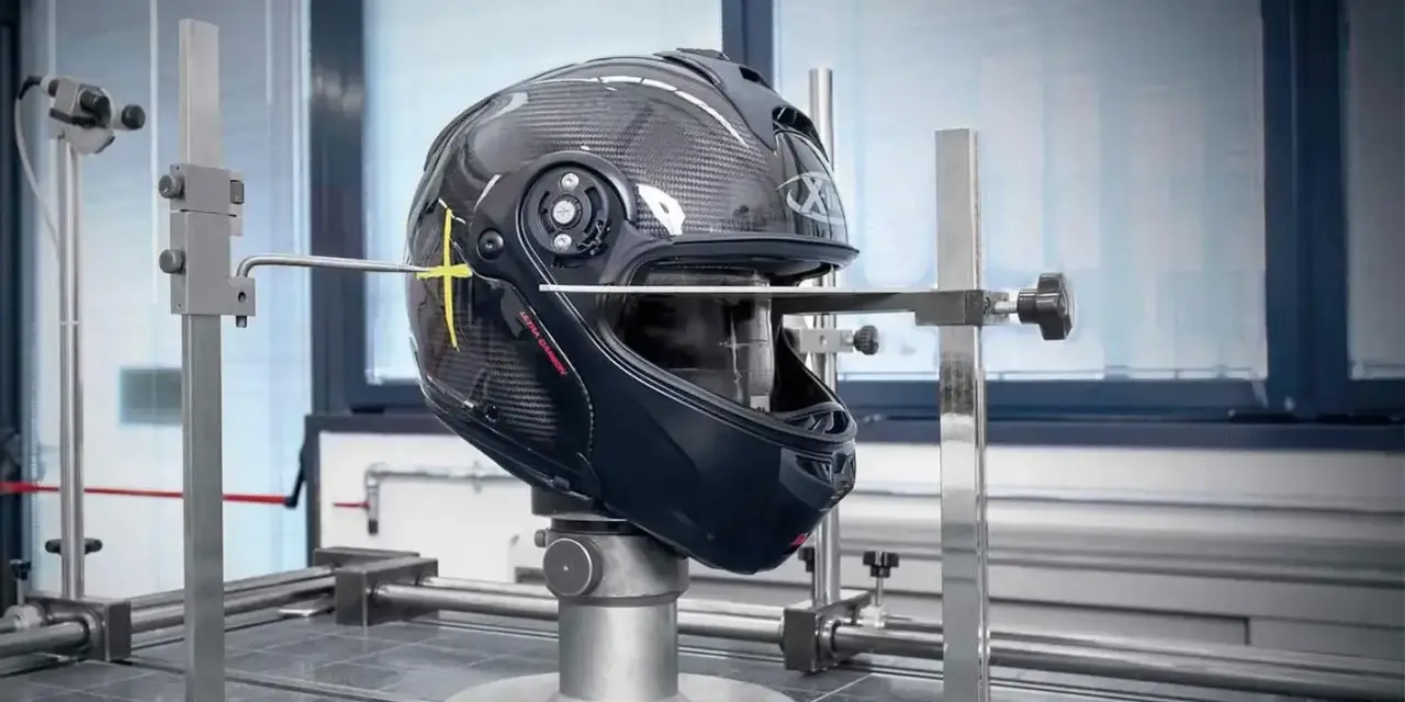 Casco in carbonio in fase di test, con strumenti di misurazione. Verifica della scadenza omologazione casco E3 per garantire la sicurezza.