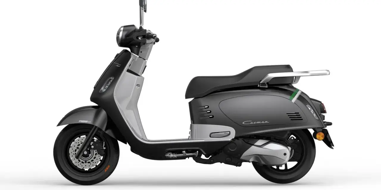 Scooter grigio con finiture argentate e dettagli verdi. Perfetto per scoprire quanti km può fare uno scooter 125 in città.