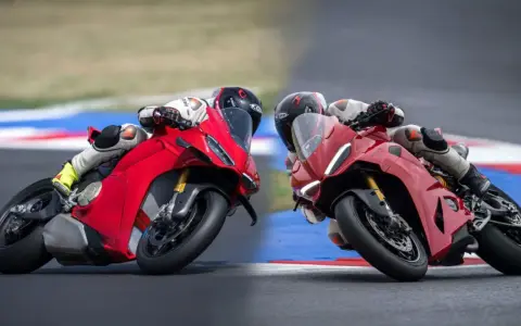Due superbike Ducati rosse sfrecciano in pista, piegando in curva con maestria.