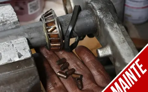 Manutenzione albero motore T-Max: cuscinetto usurato e rullini sparsi nella mano.