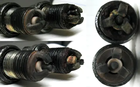 Candele auto sporche e usurate, con depositi carboniosi evidenti. Questi sono chiari sintomi candele da cambiare per un motore efficiente.