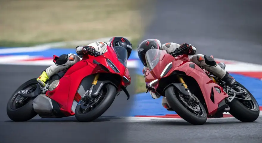 Due superbike Ducati rosse sfrecciano in pista, piegando in curva con maestria.