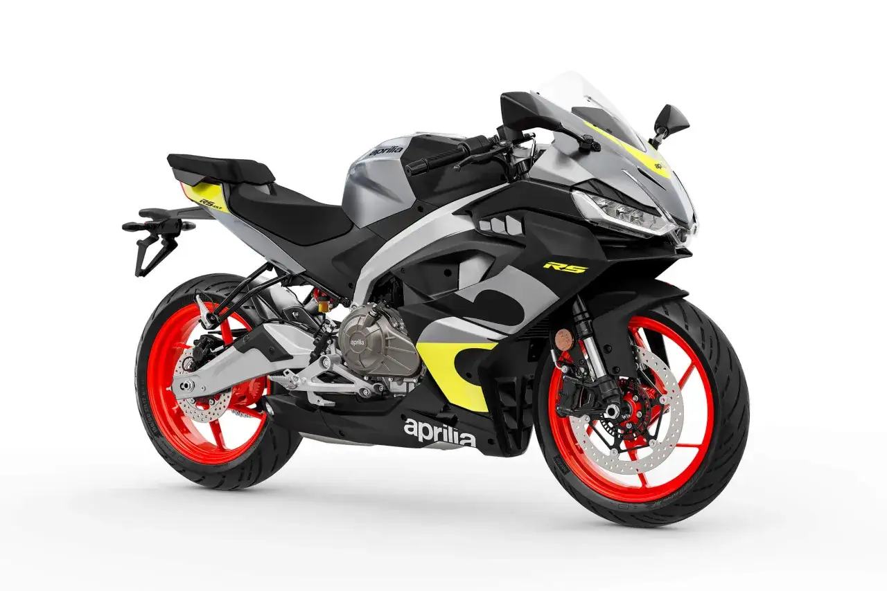 Aprilia RS 457 carenata, sportiva con livrea grigio-nera e dettagli gialli, cerchi rossi.